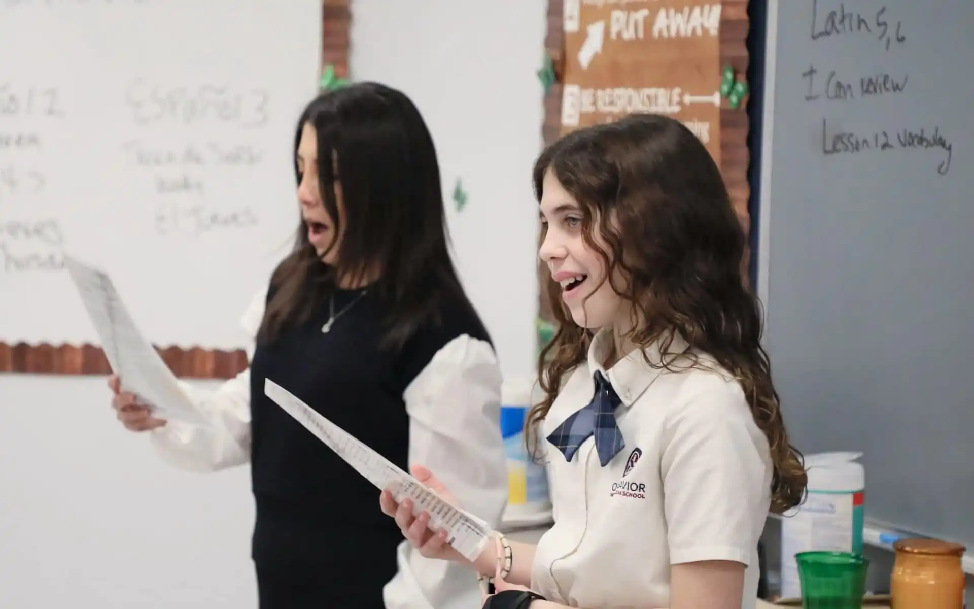 Two feamail students sing in a classroom.